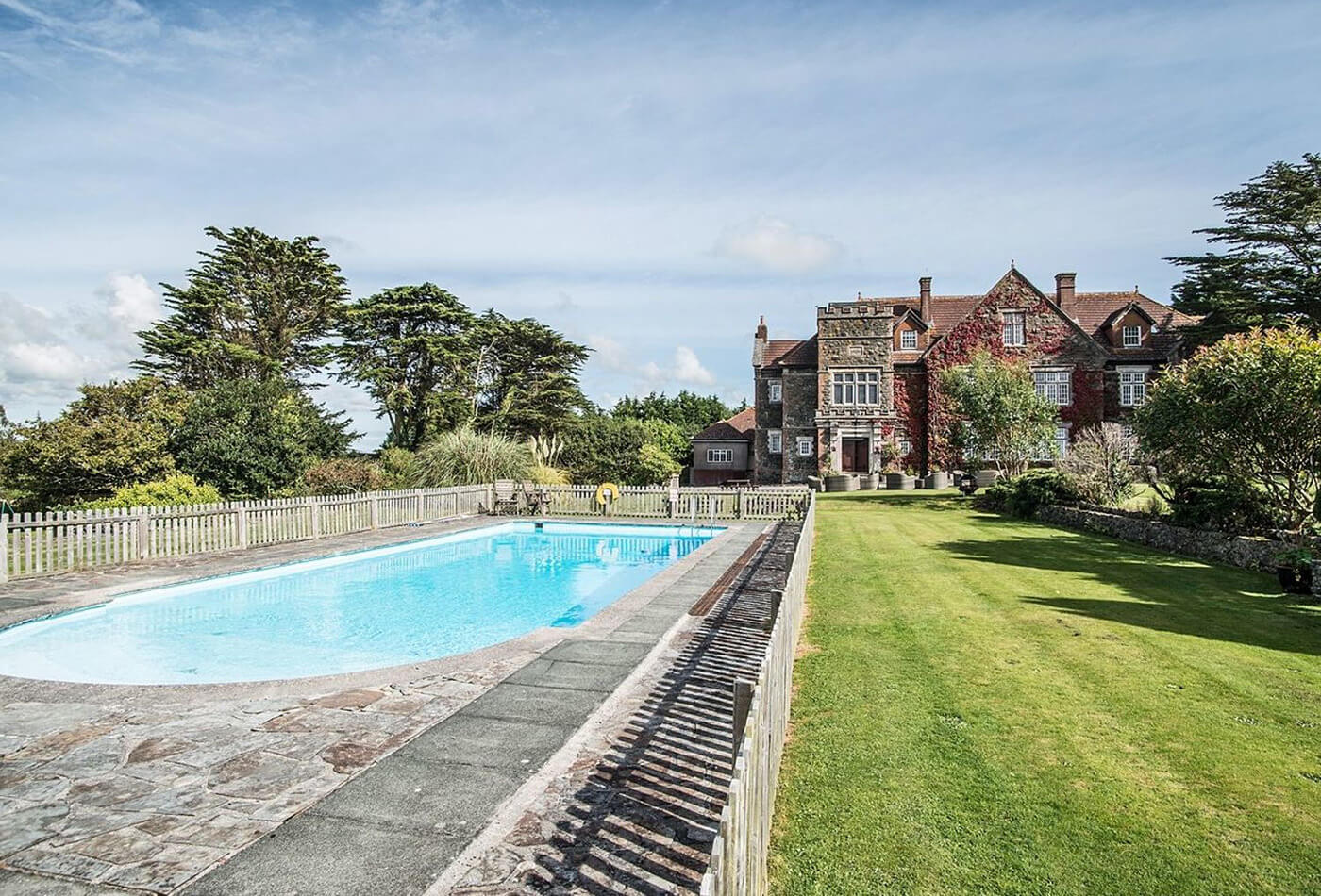 Holiday cottage with a pool - outdoor pool with Alston Hall in the background.