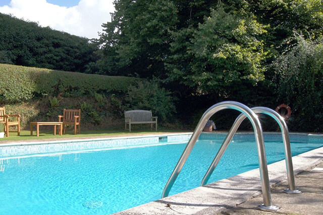 Installing a swimming pool in a holiday home - outside pool with steps.