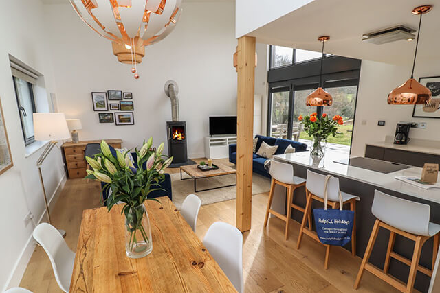 Primrose Barn - open kitchen, dining living area with rural views through patio doors and modern interiors.