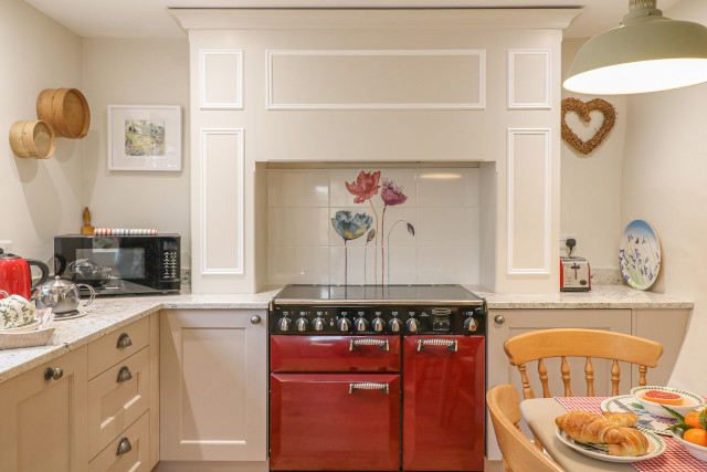 Kitchen with aga and other electrical appliances.