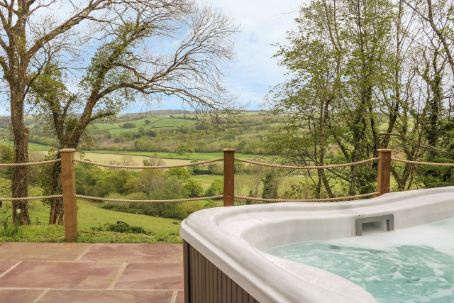 Hot tub with a view of the Devon countryside.