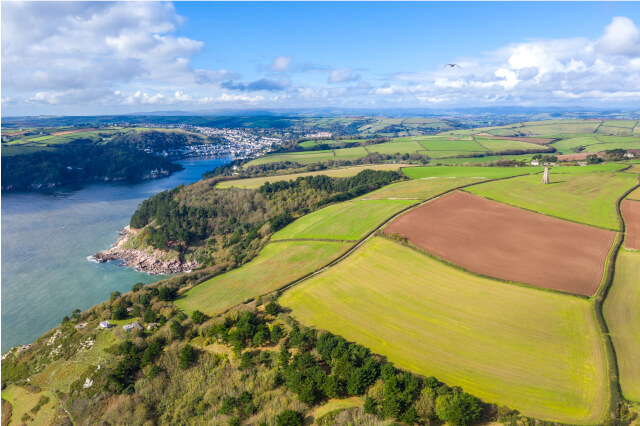 Aerial view of Dartmouth and Kingswear coast with The Daymark in the fields