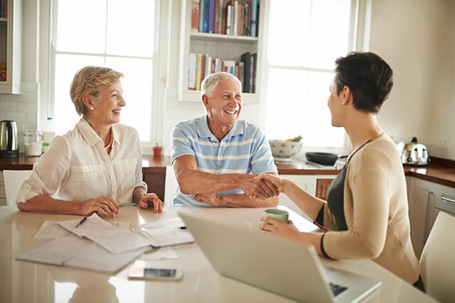 Senior couple getting financial advice on buying a holiday home