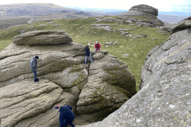 Climbers planning their route on High Man, Haytor.