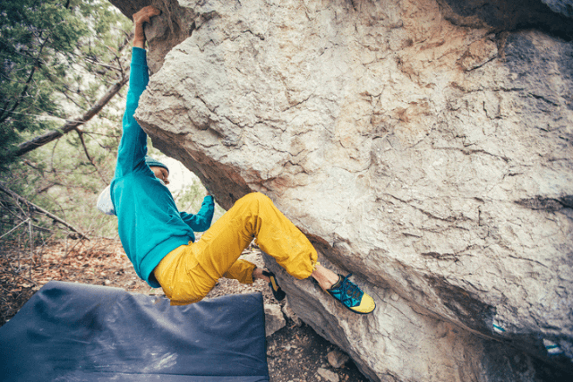 Man tackling a boulder problem.