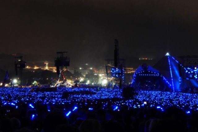 A sea of blue lights in the crowd during Coldplay's headline set on the pyramid stage in 2016 at Glastonbury Festival in Somerset.