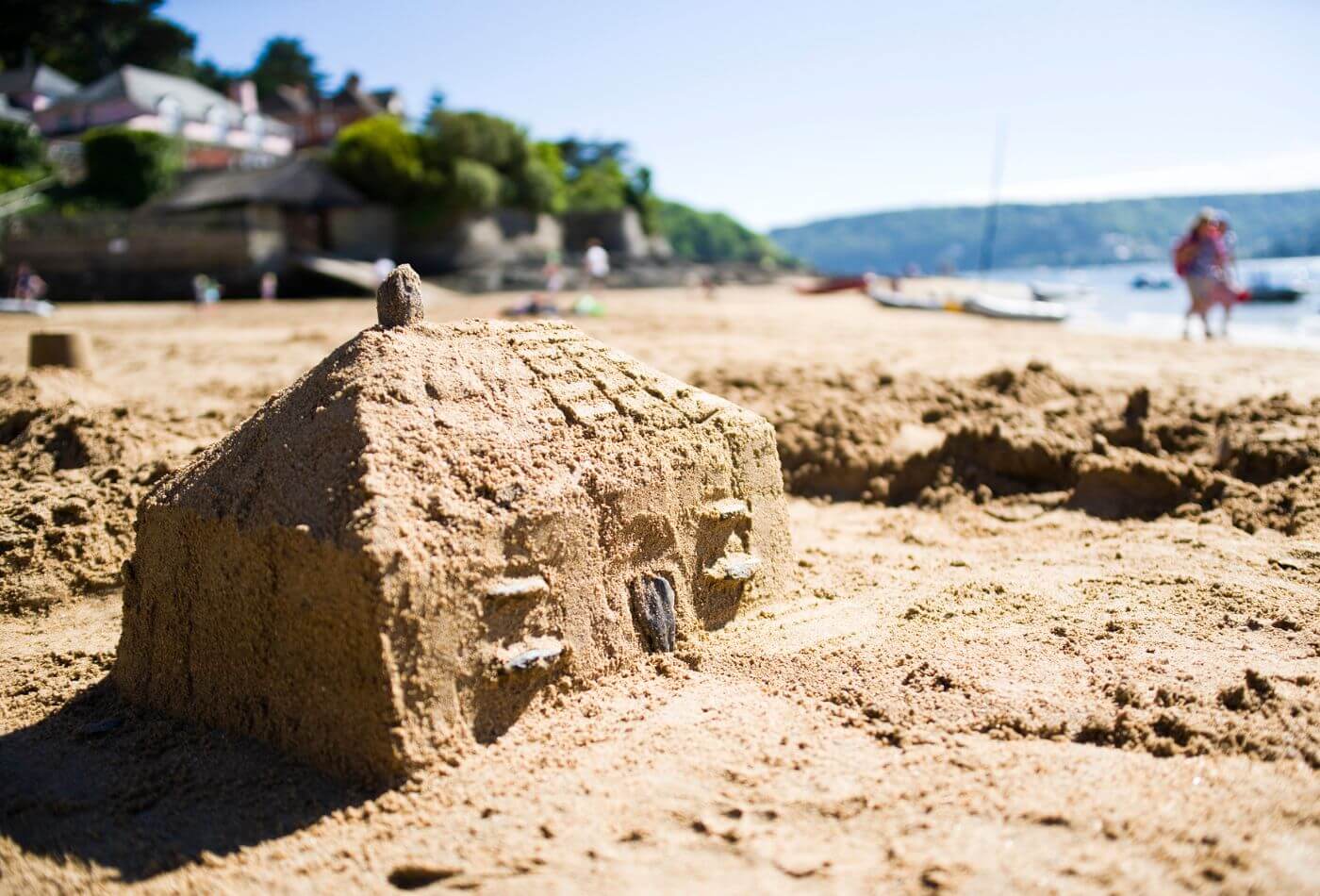 A house made of sand on the beach.