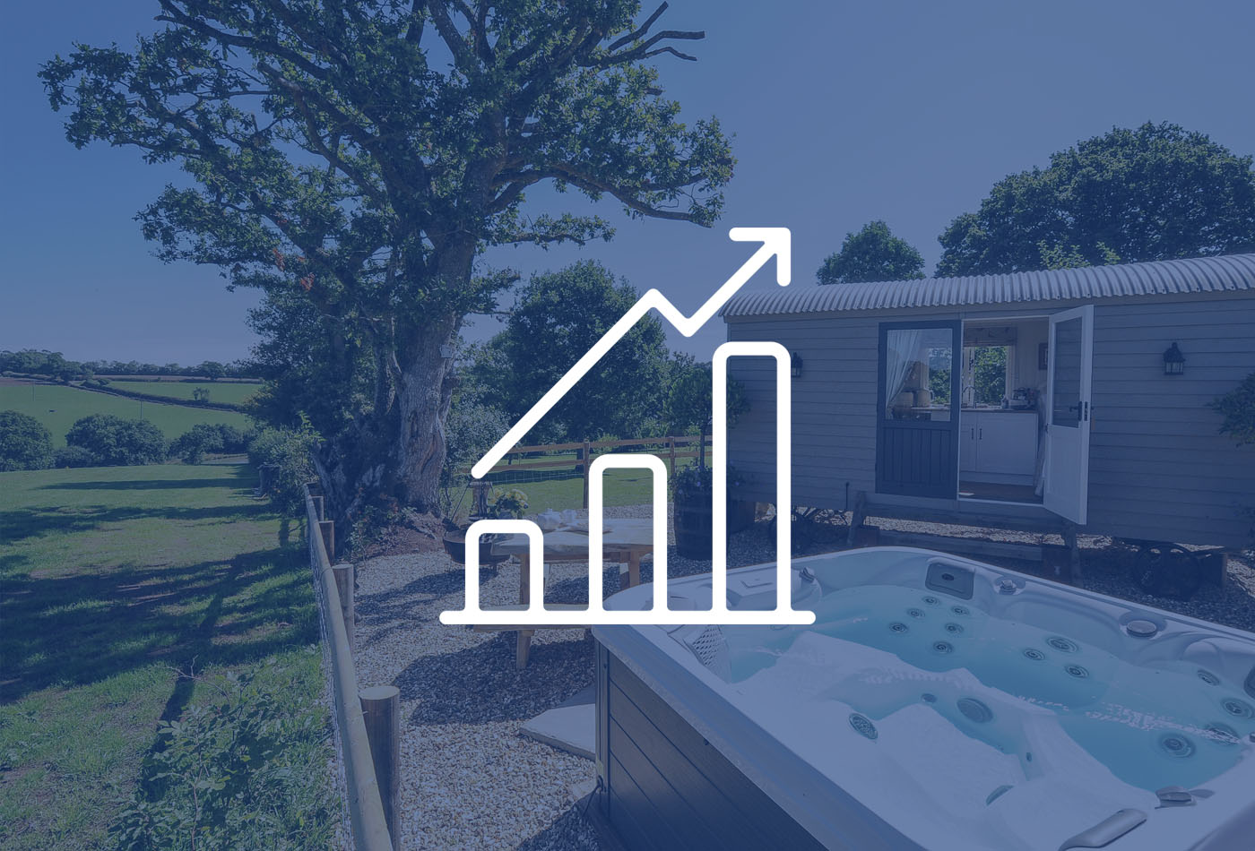 South West Holiday let Market Insight Report 2024 | A translucent blue background and grpah icon over an image of the shepherds' hut at Orchard Retreat, Witheridge