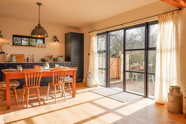 Kitchen-diner filled with sunlight at Church Farm Dairy, Thorverton