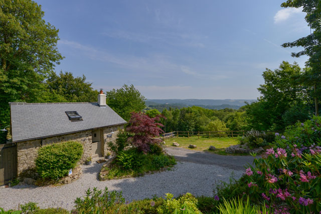 View over Dartmoor with a holiday cottage in the foreground at Beckaford View, Manaton.