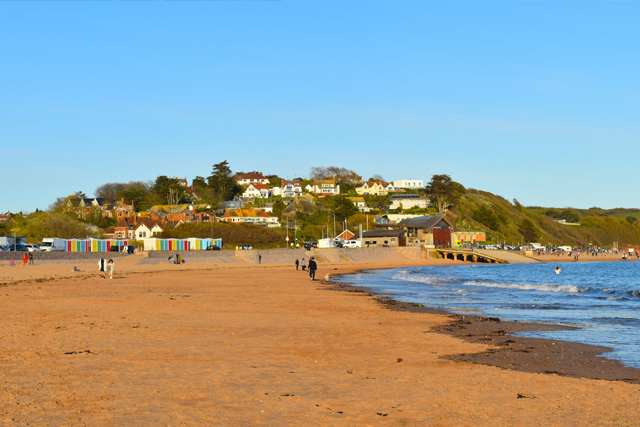 View along Exmouth Beach on a sunny day, with the lifeboat station in the background