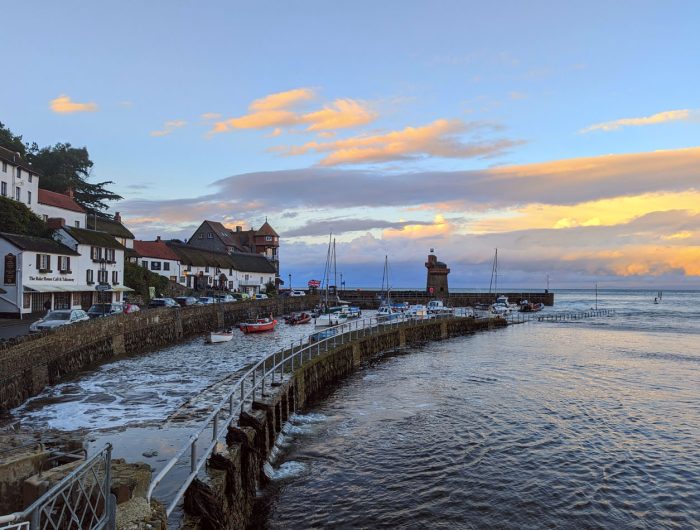 View of Lynmouth harbour and the sea at sunset
